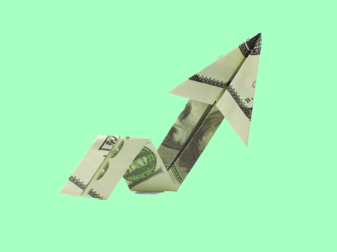Dollar bill folded into upward arrow