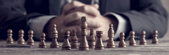 Hands and chess pieces on board